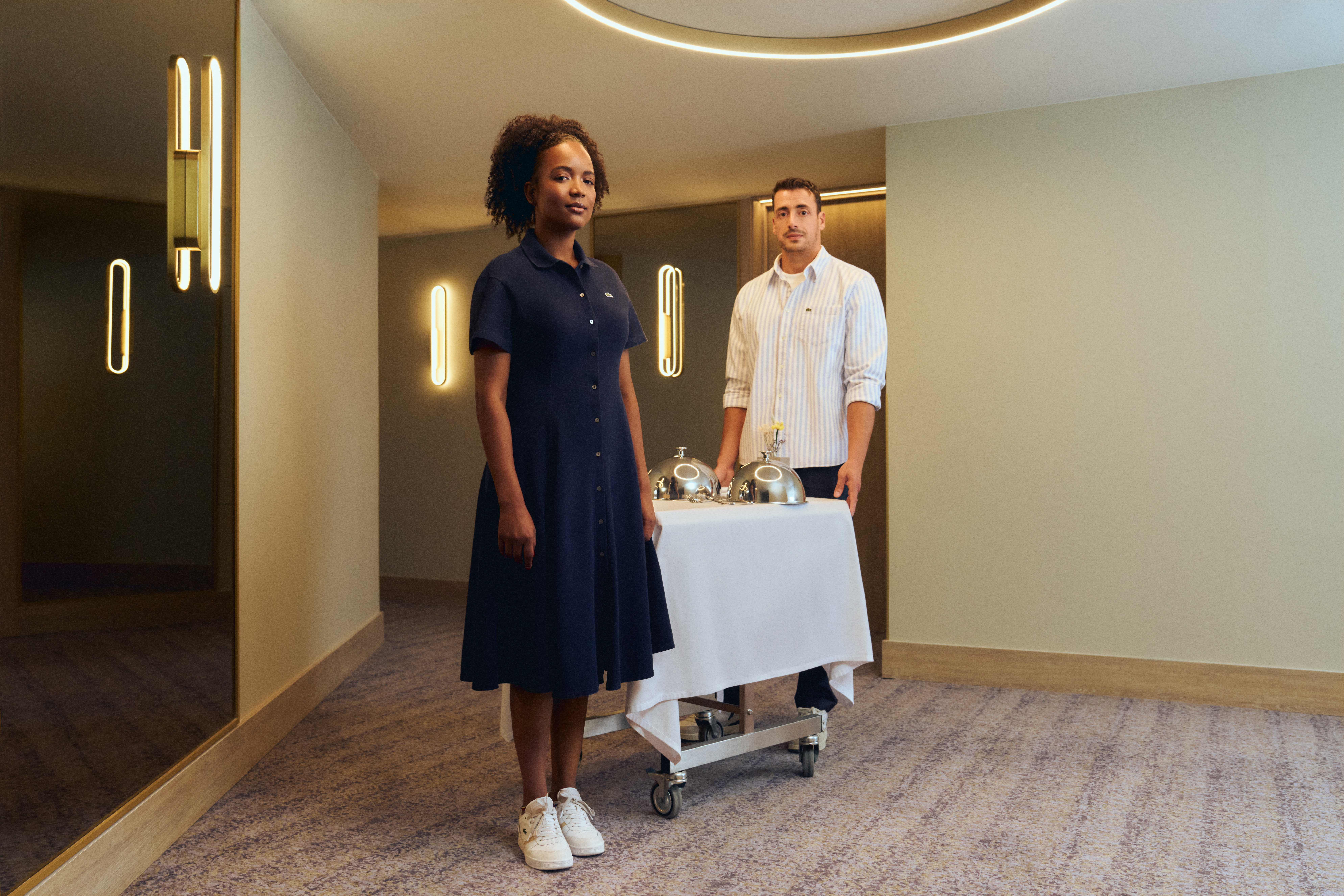 a man and woman standing next to a table