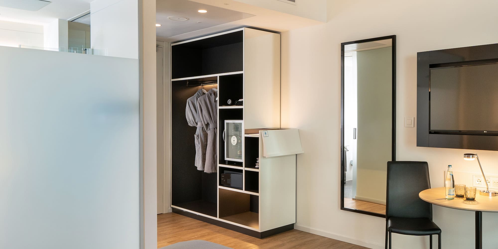 a room with a mirror and a closet