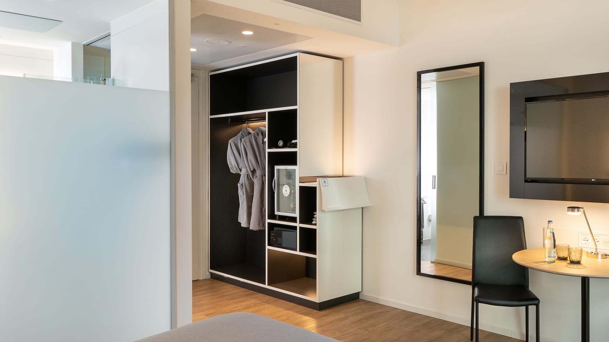 a room with a mirror and a closet