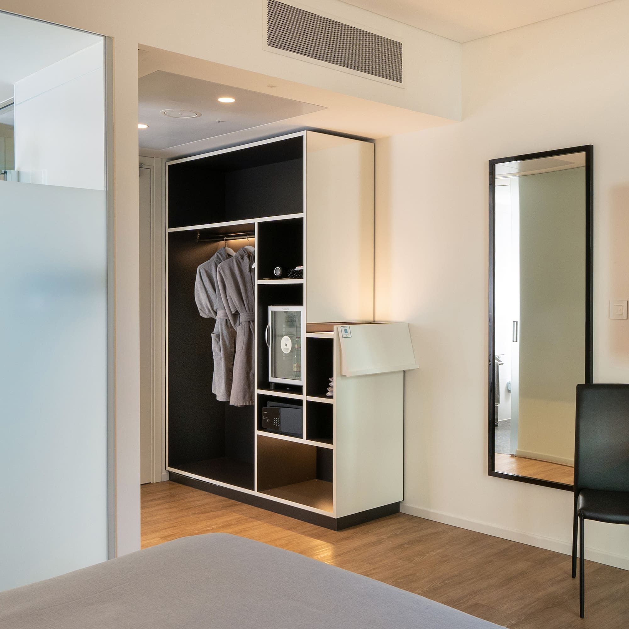 a room with a mirror and a closet