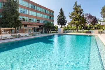 a swimming pool in front of a building