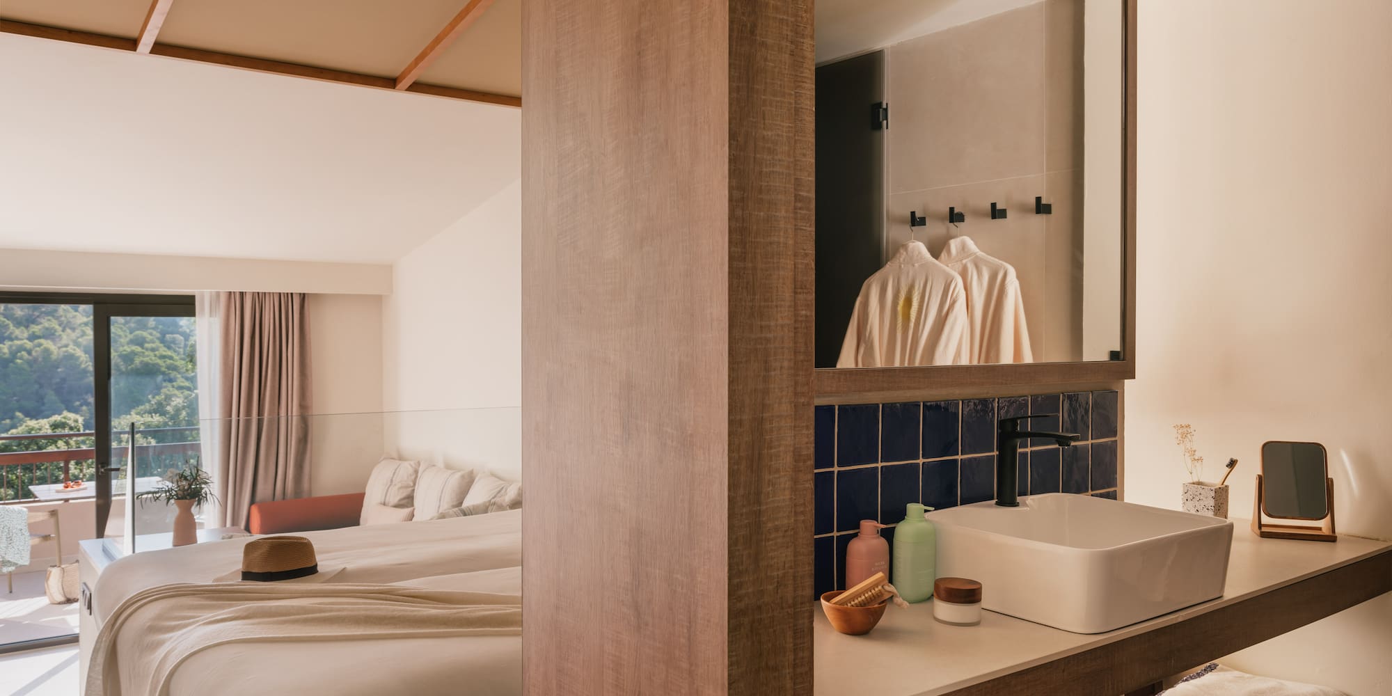 a bathroom with a mirror and a bed