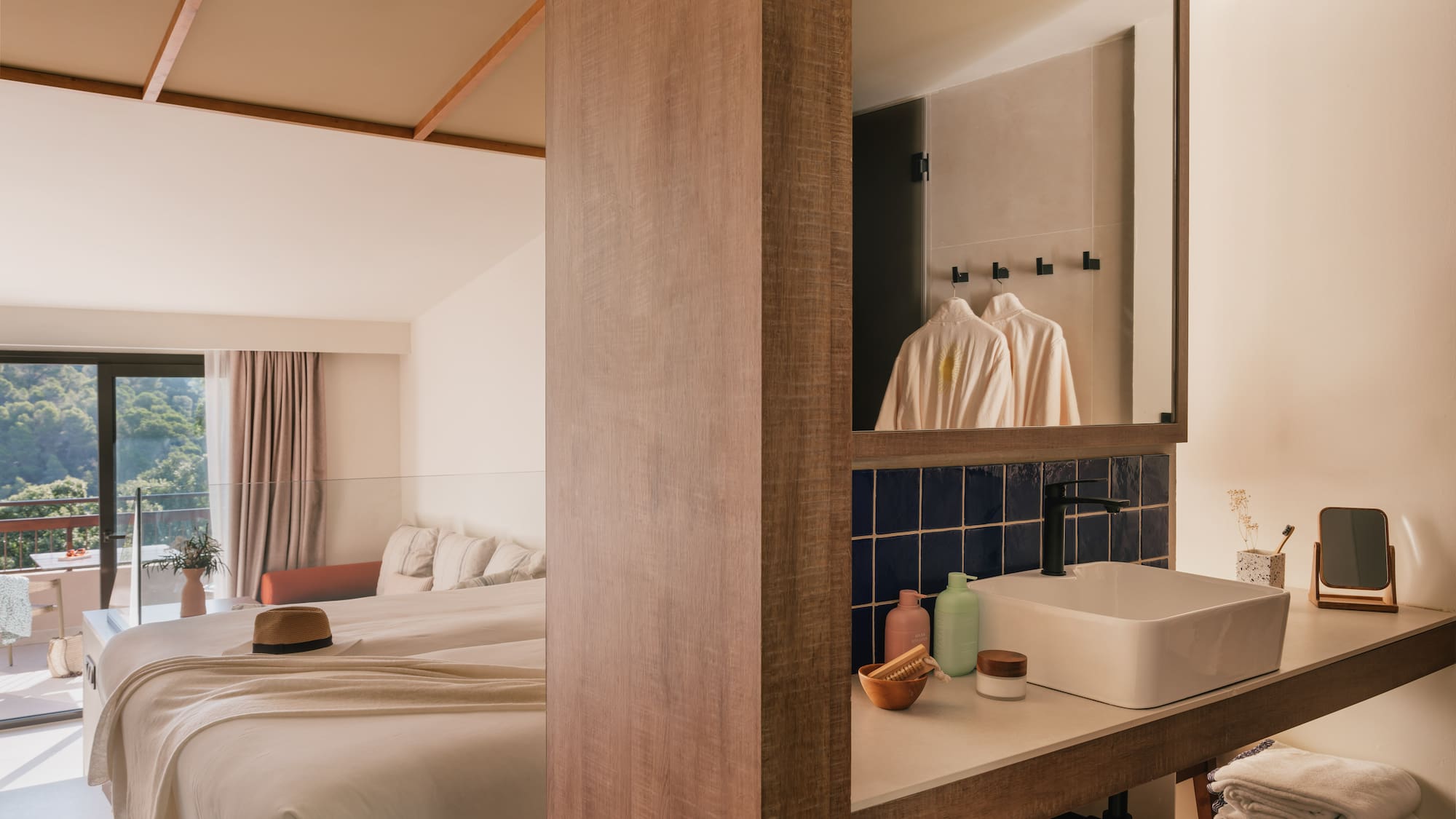 a bathroom with a mirror and a bed