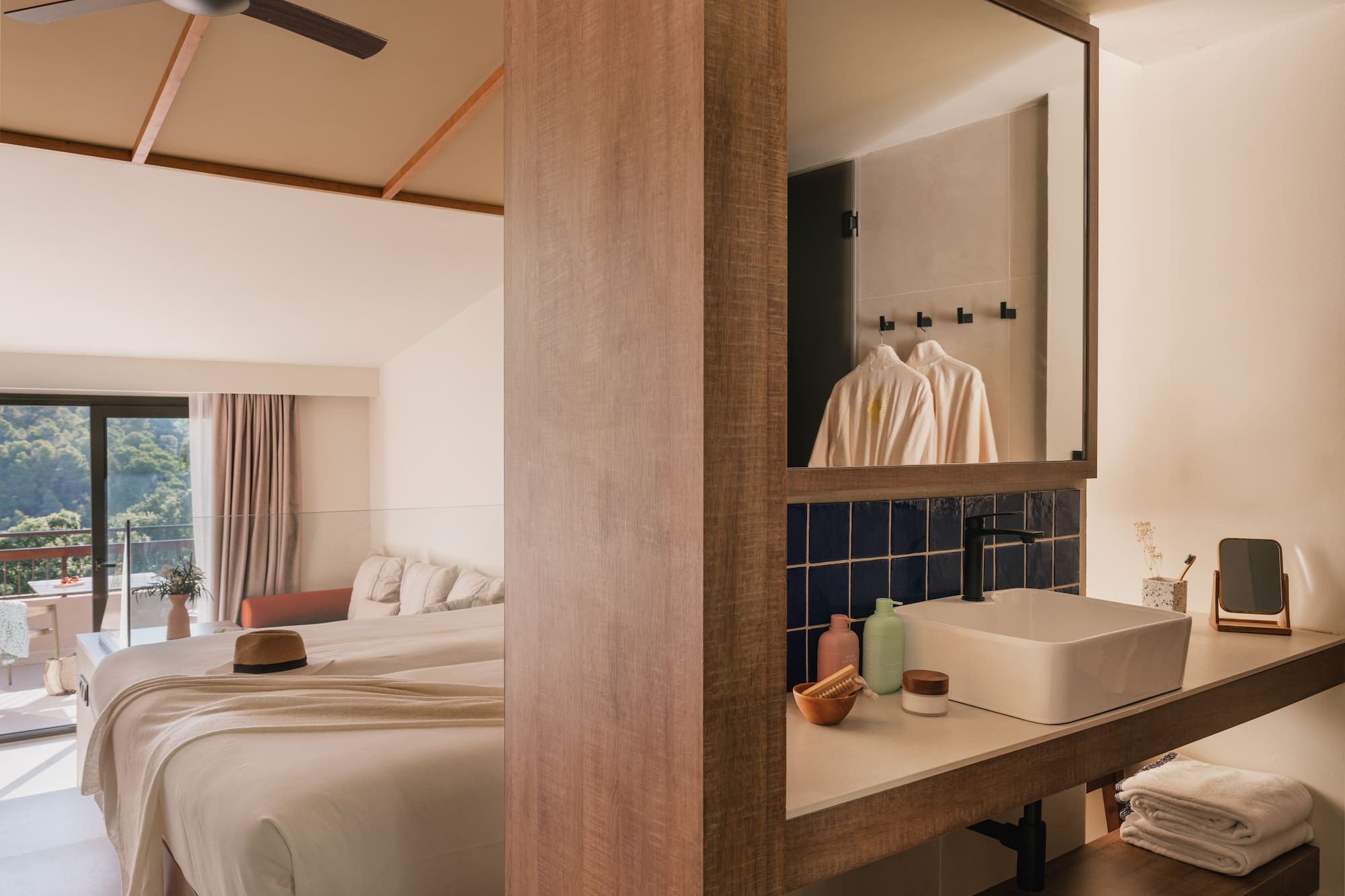 a bathroom with a mirror and a bed