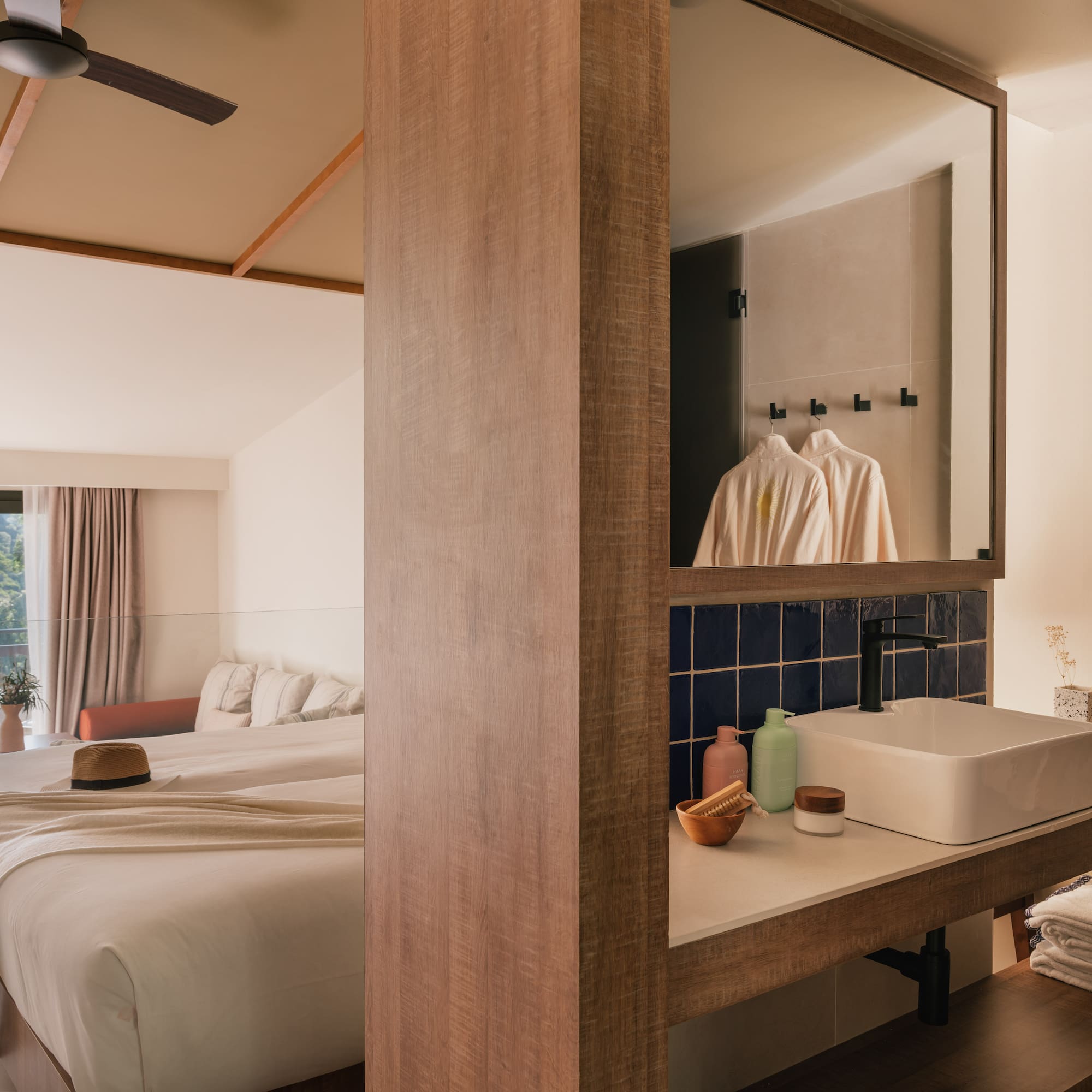 a bathroom with a mirror and a bed