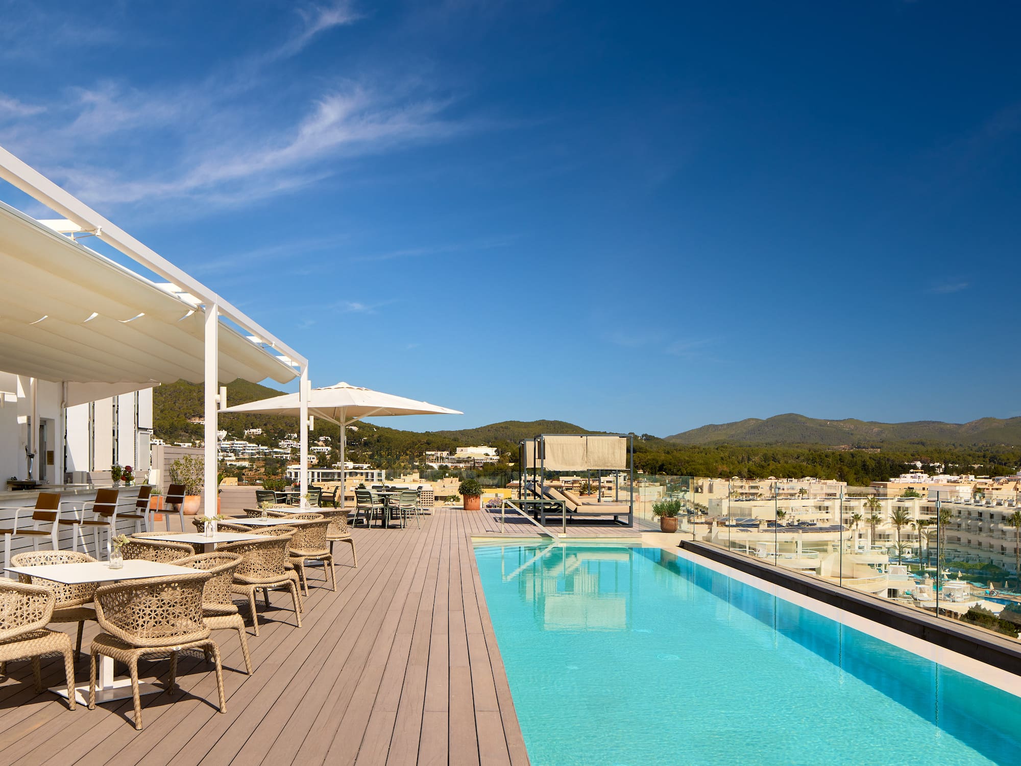 a pool with tables and chairs on a deck