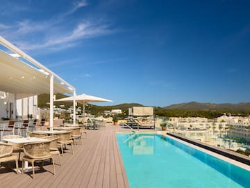 a pool with tables and chairs on a deck