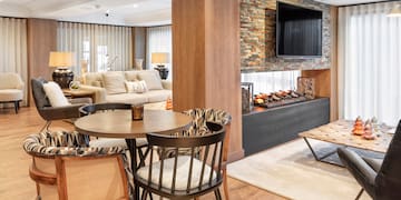 a living room with a fireplace and a table