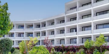 a building with many balconies and plants