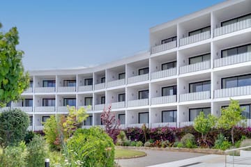 a building with many balconies and plants