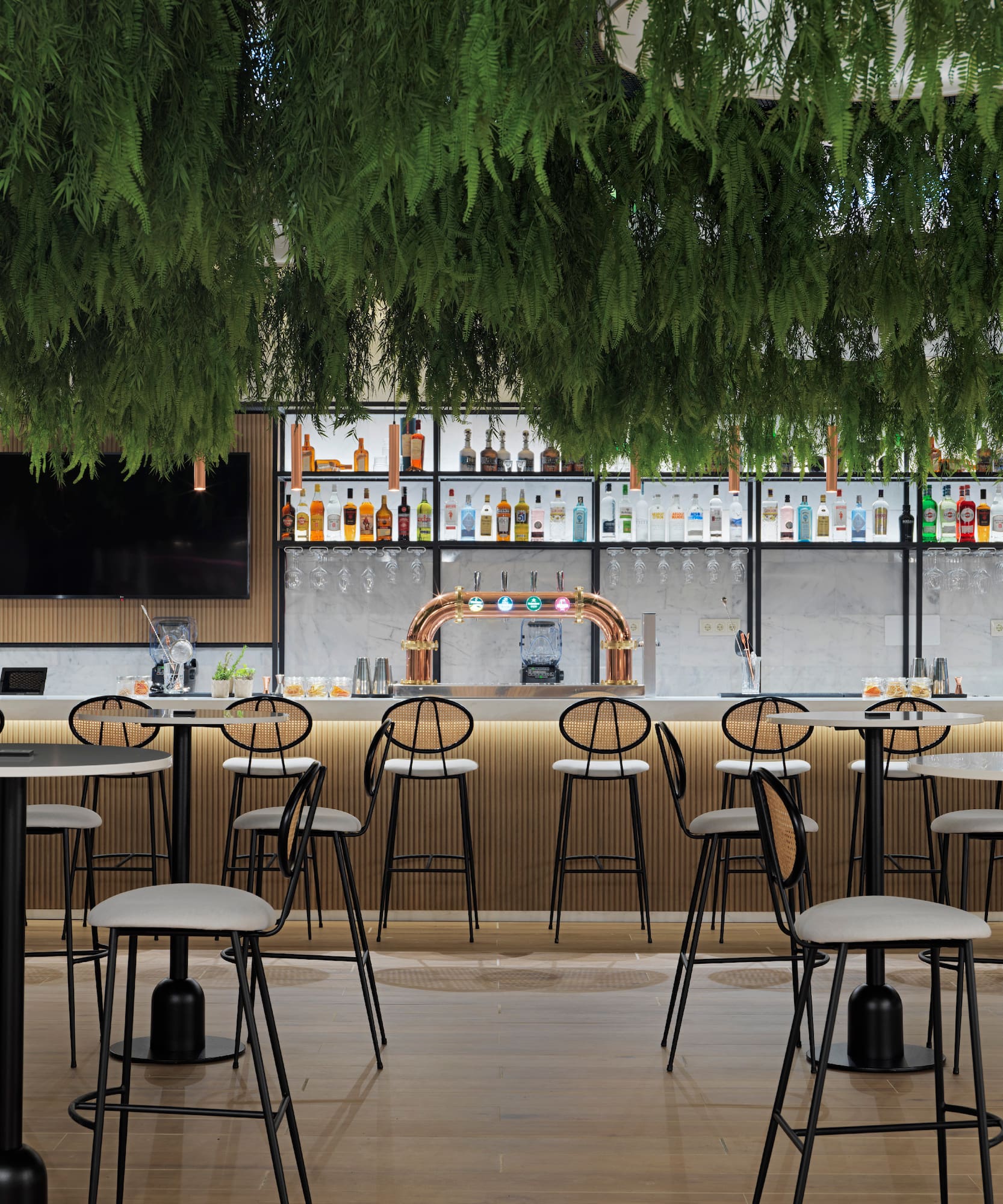 a bar with a lot of chairs and a tv