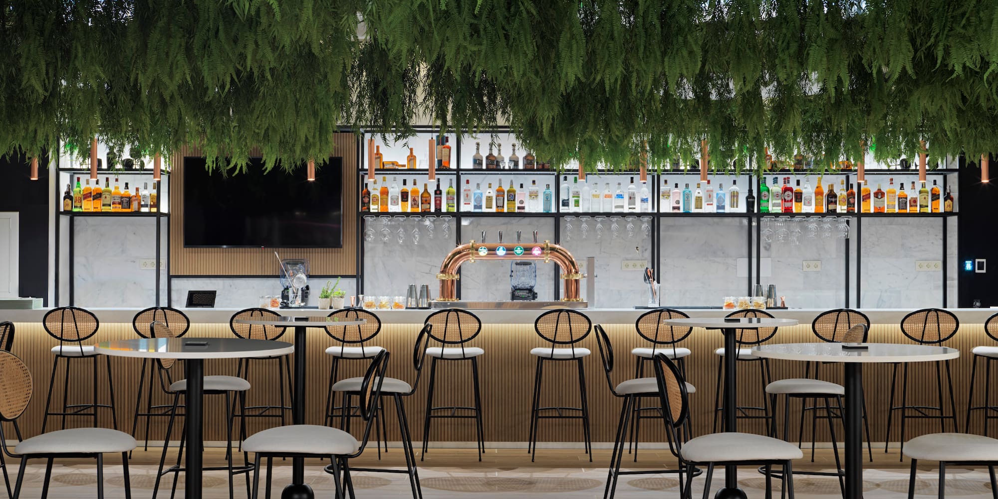 a bar with a lot of chairs and a tv