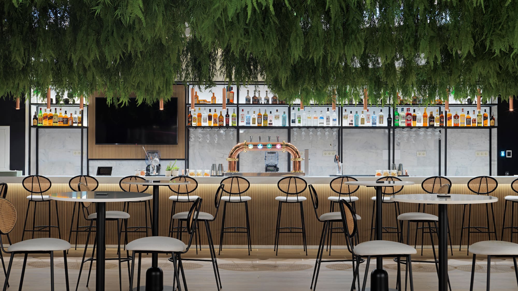 a bar with a lot of chairs and a tv