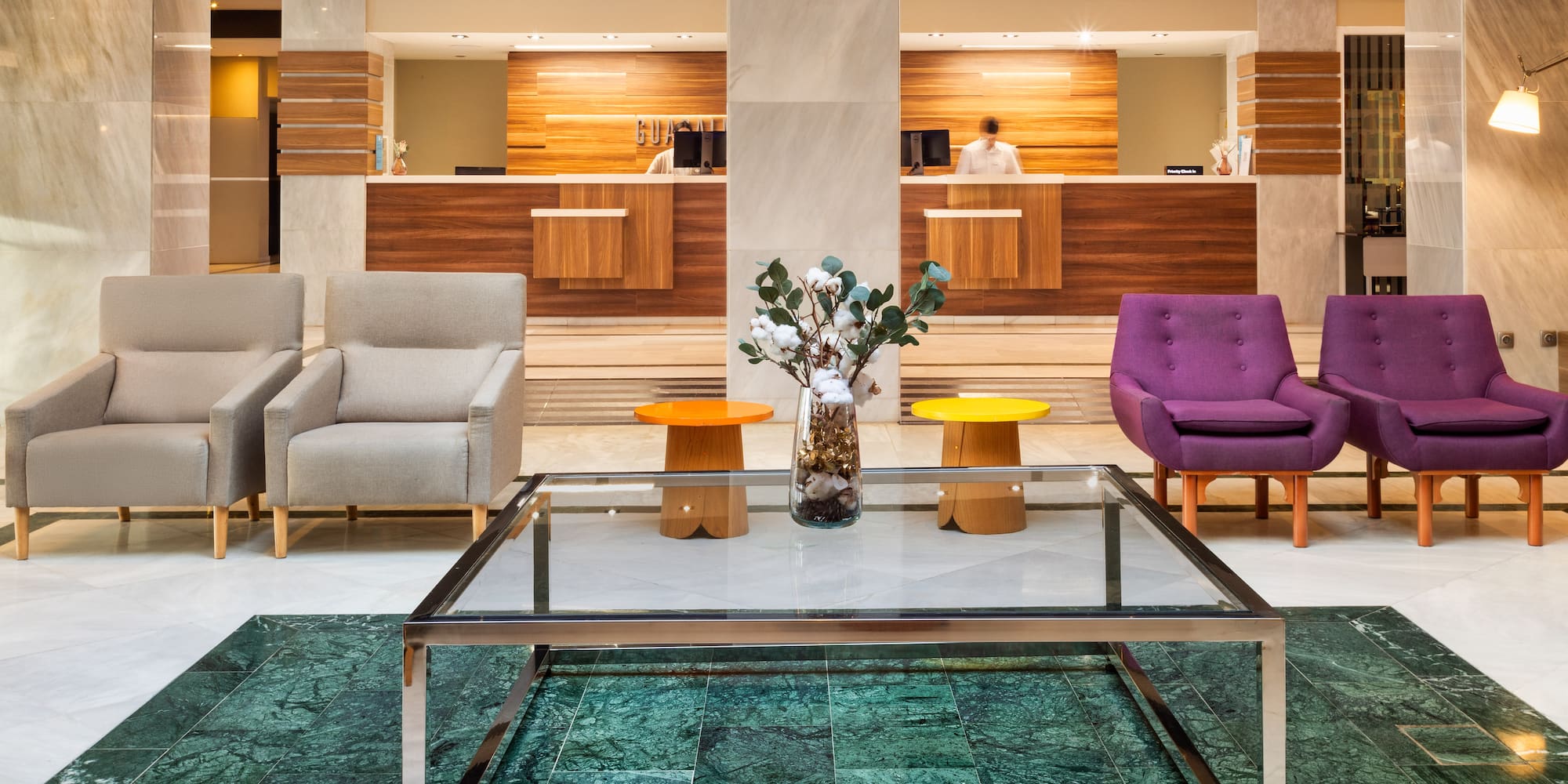 a lobby with a glass table and chairs
