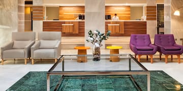 a lobby with a glass table and chairs