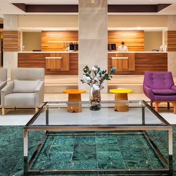 a lobby with a glass table and chairs