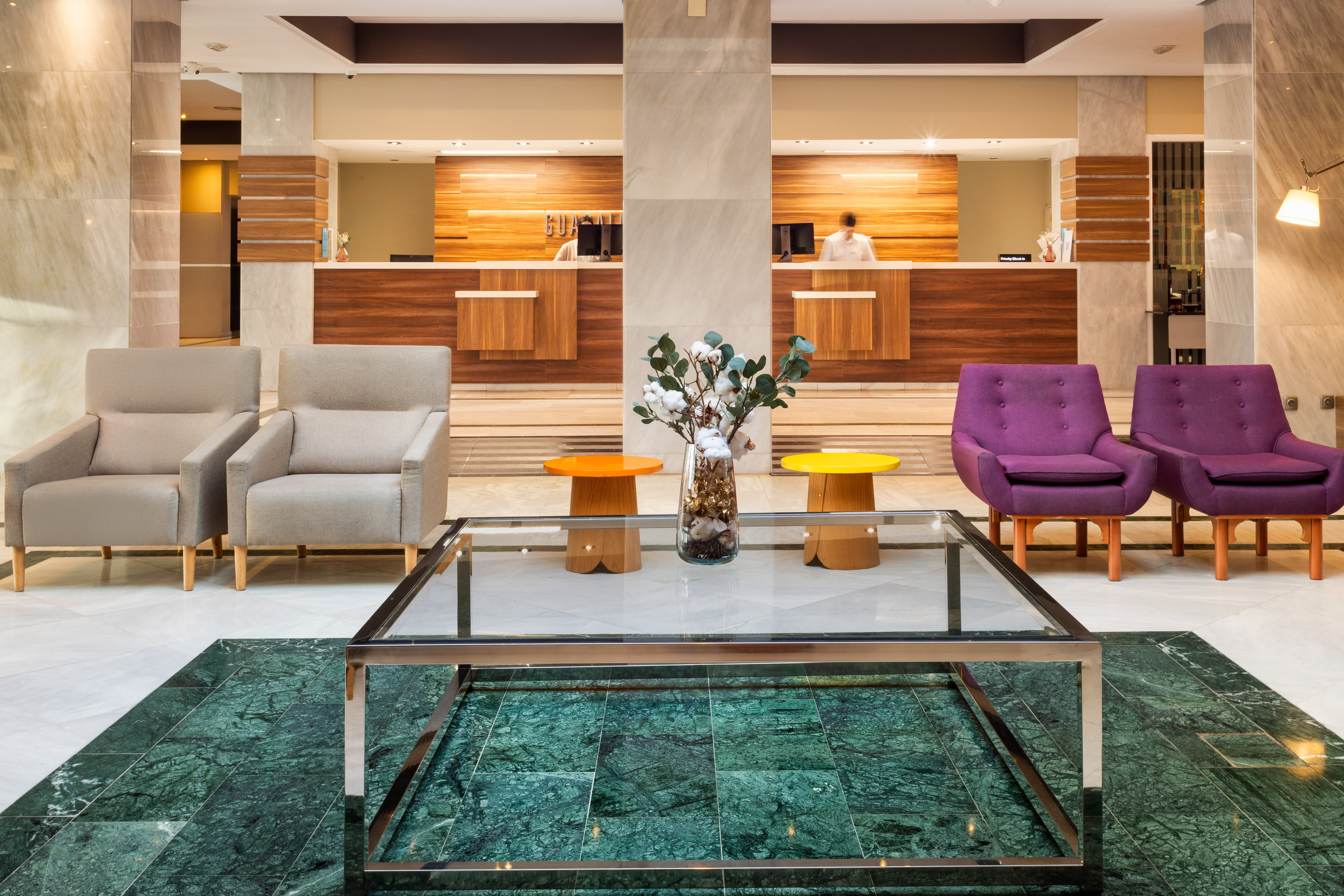 a lobby with a glass table and chairs