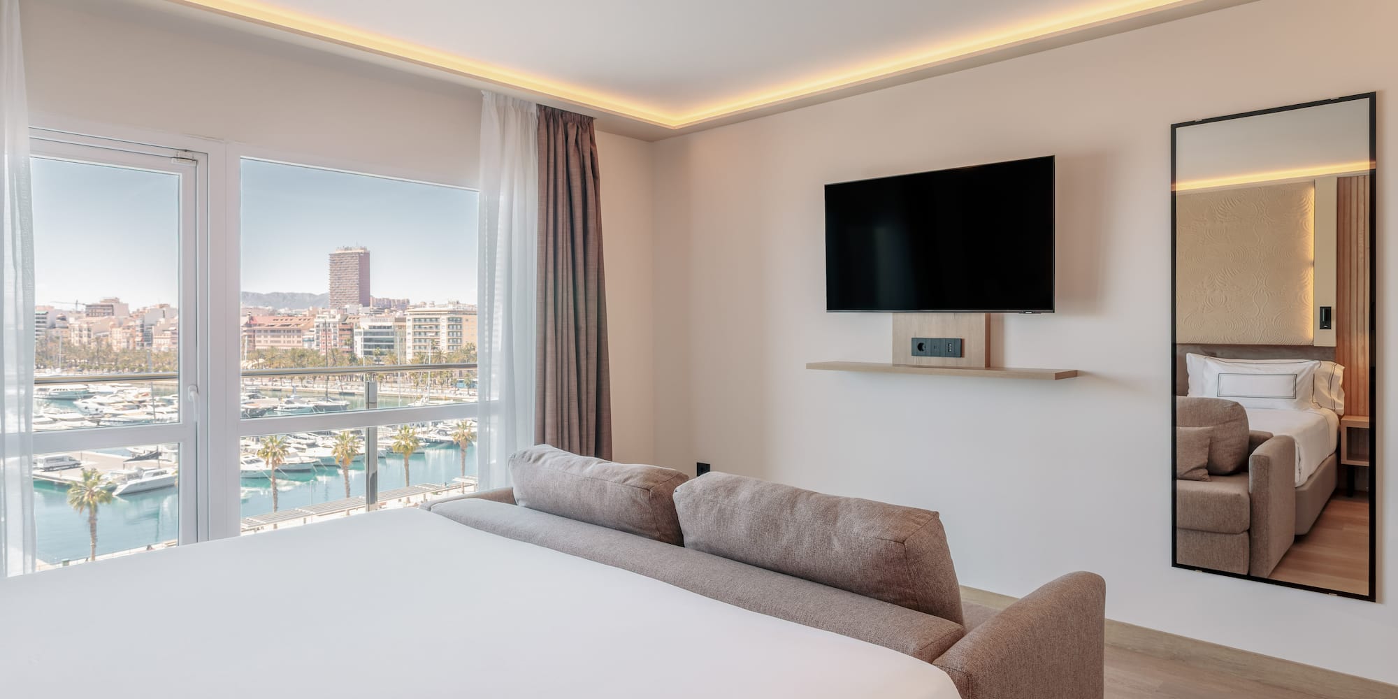 a room with a bed and a television