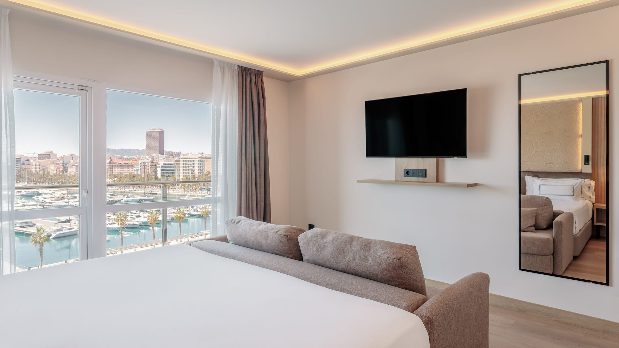 a room with a bed and a television