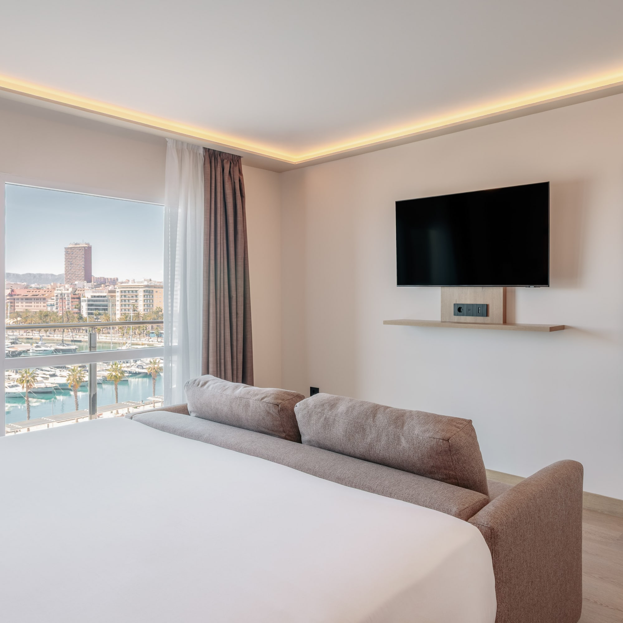 a room with a bed and a television