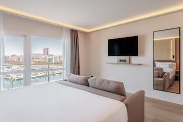 a room with a bed and a television