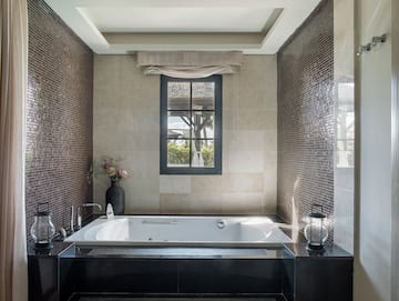 a bathroom with a tub and a window