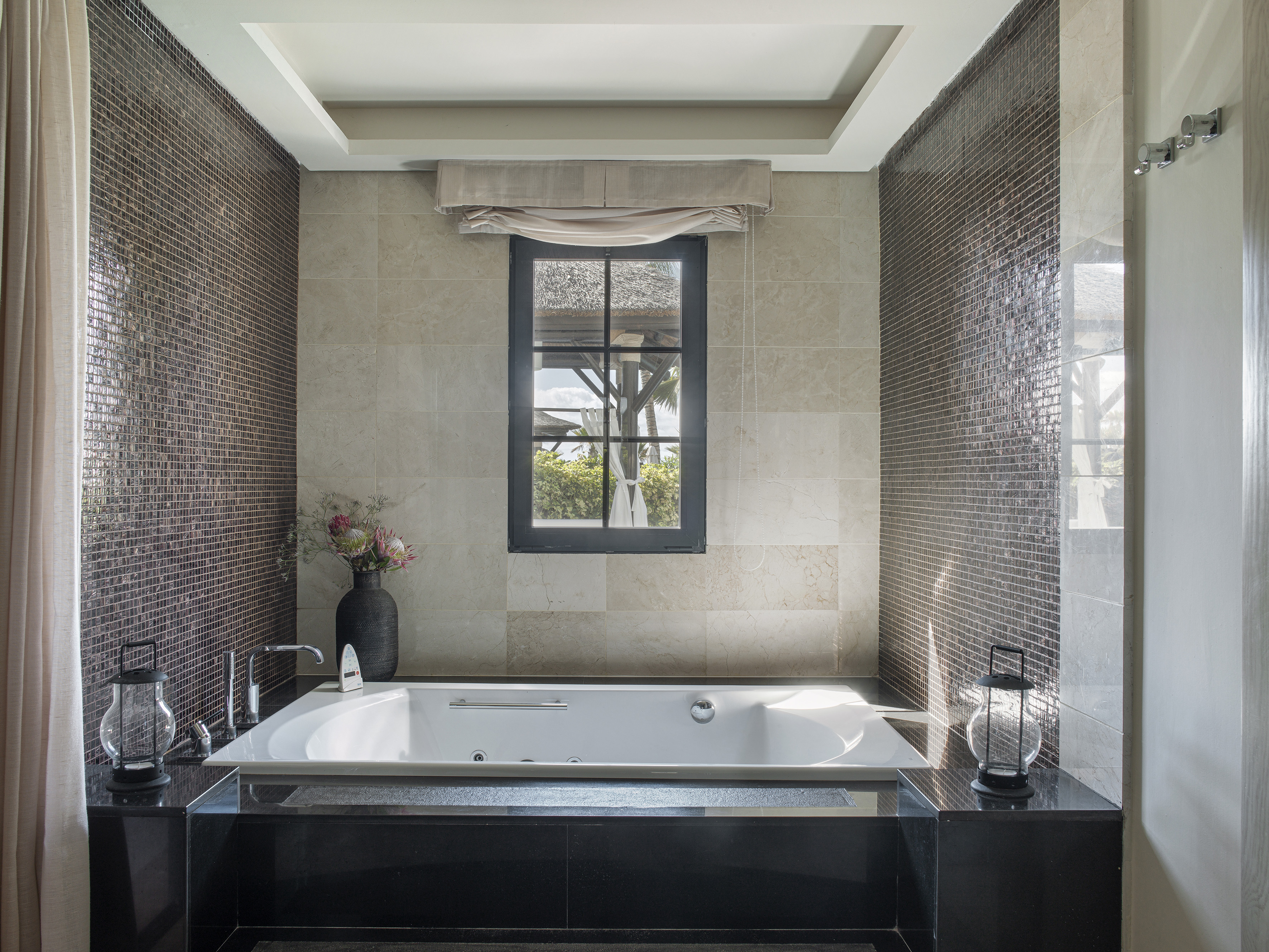 a bathroom with a tub and a window