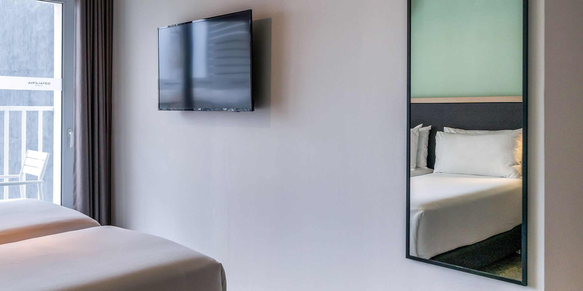 a mirror on the wall next to a bed