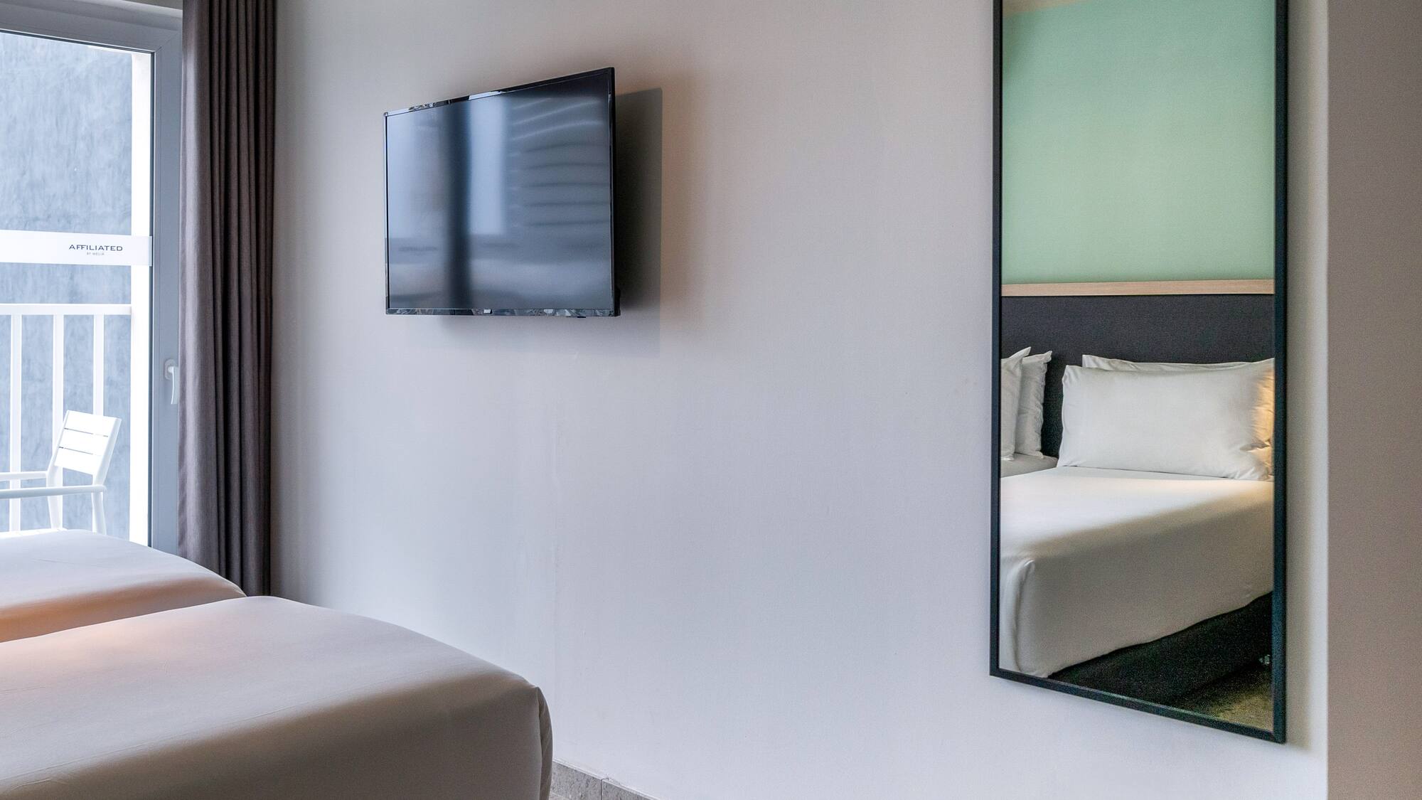 a mirror on the wall next to a bed