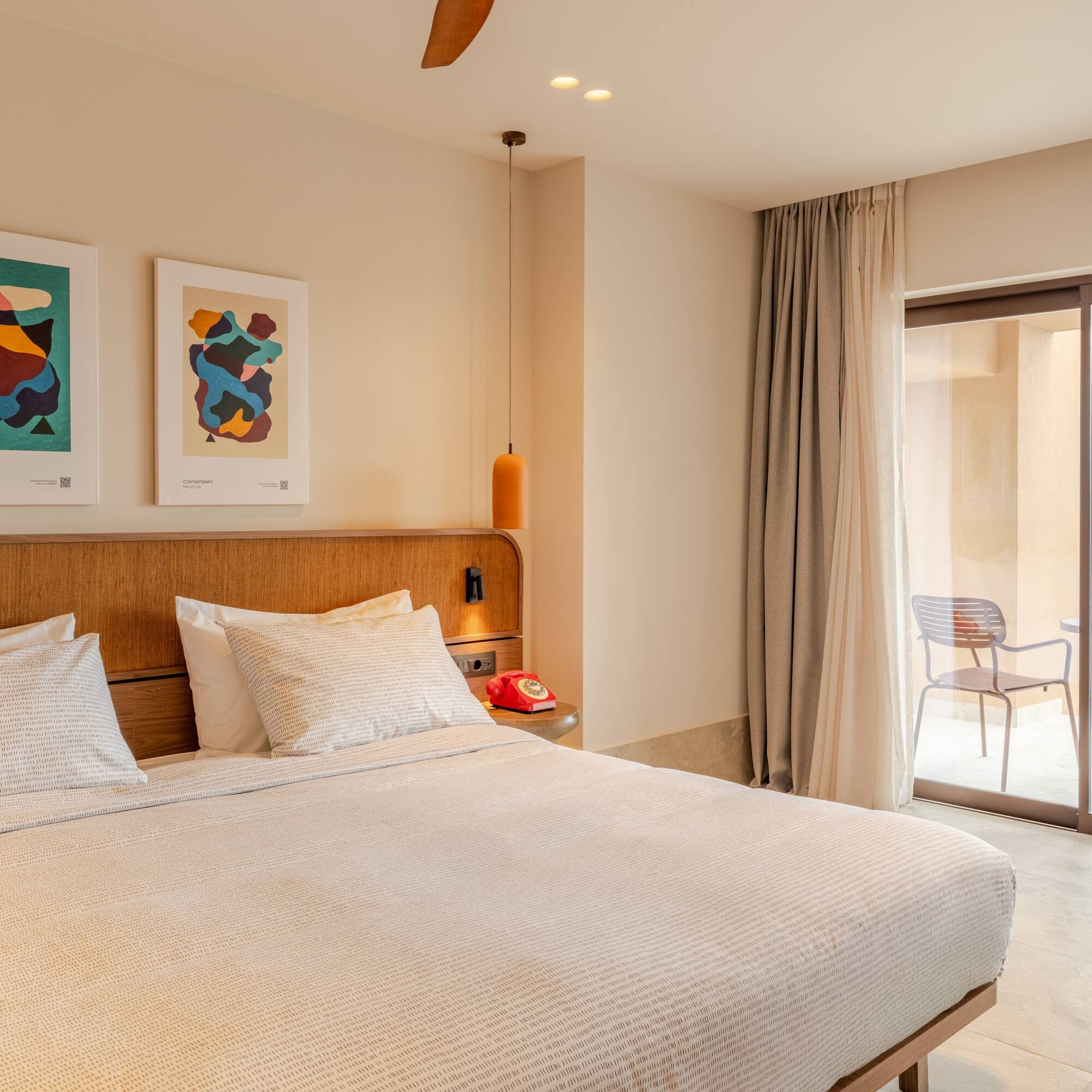 a bed with a wood headboard and a ceiling fan