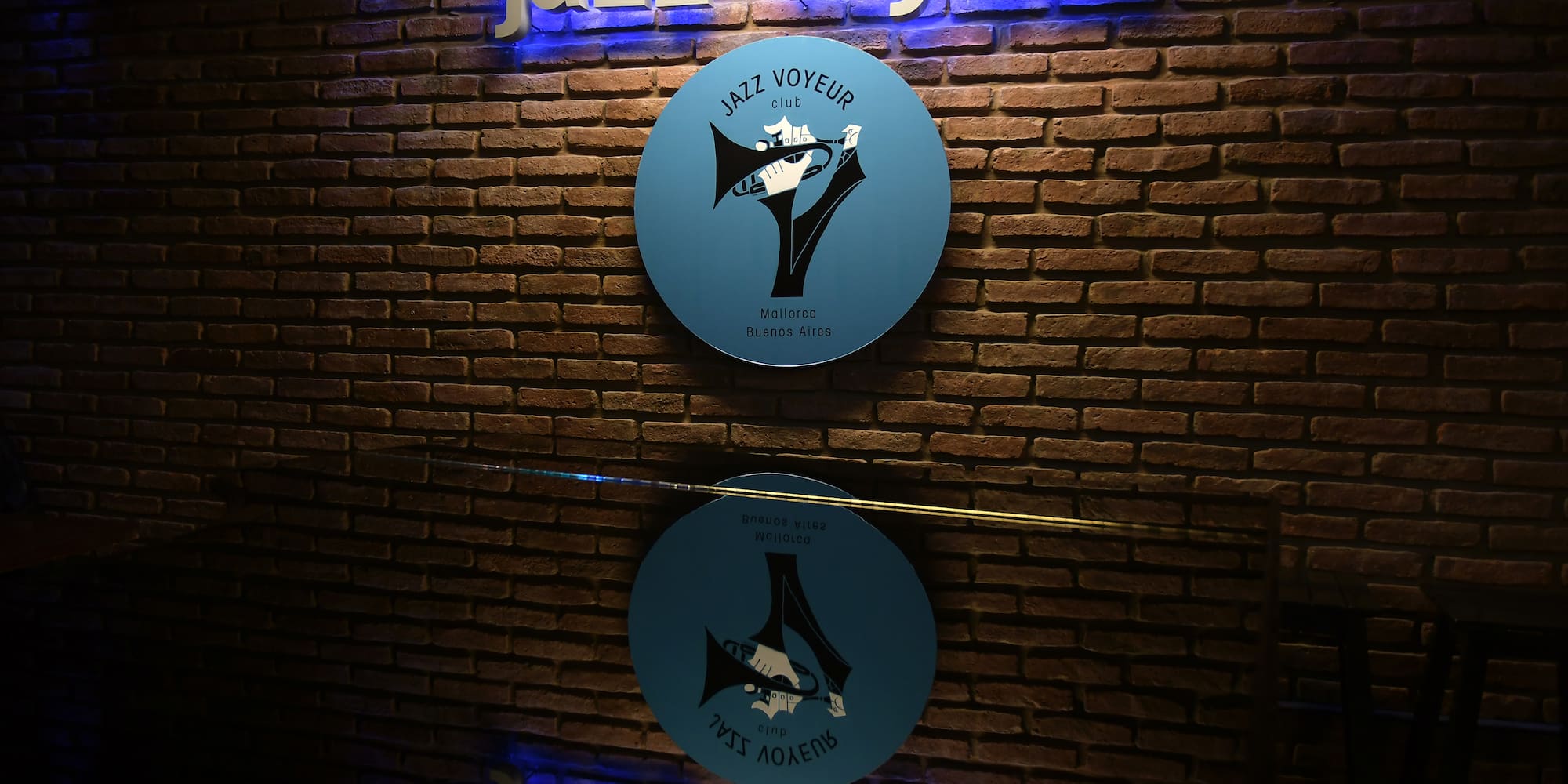 a sign on a brick wall