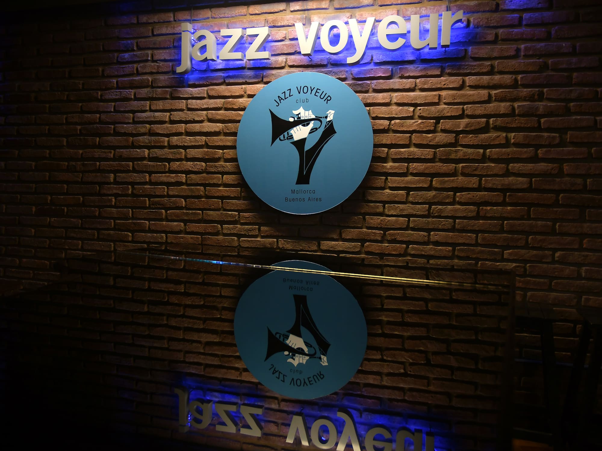 a sign on a brick wall