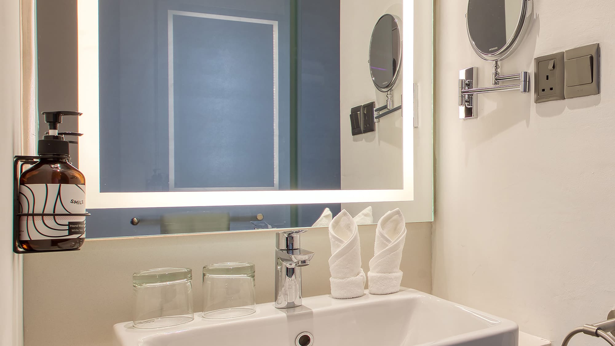 a bathroom with a mirror and sink