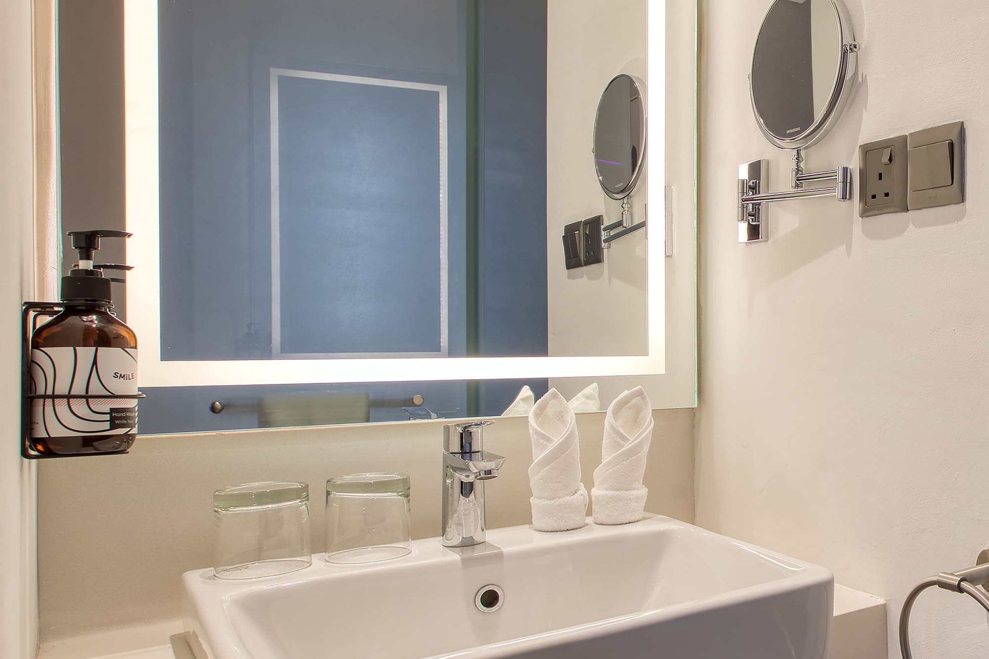 a bathroom with a mirror and sink