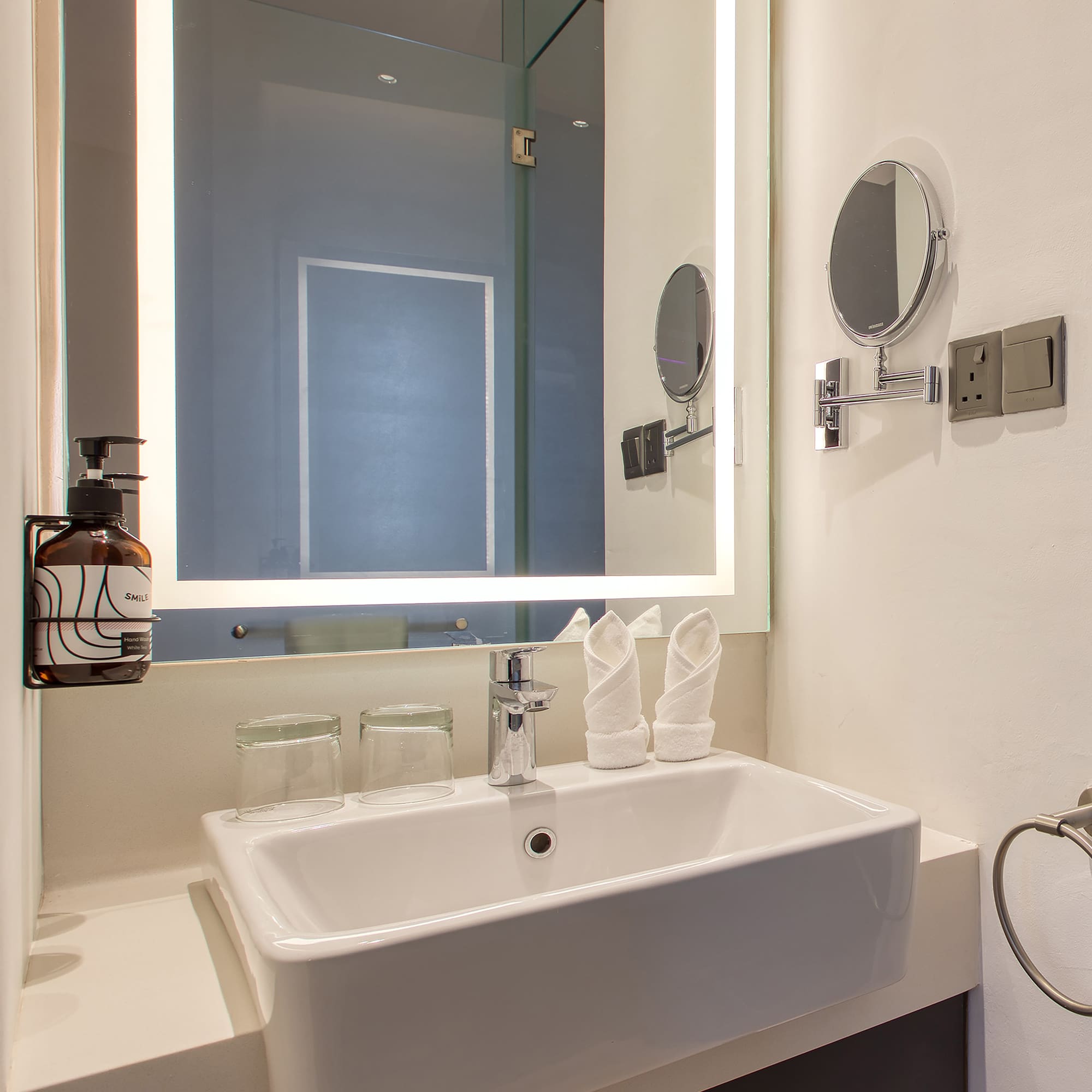 a bathroom with a mirror and sink