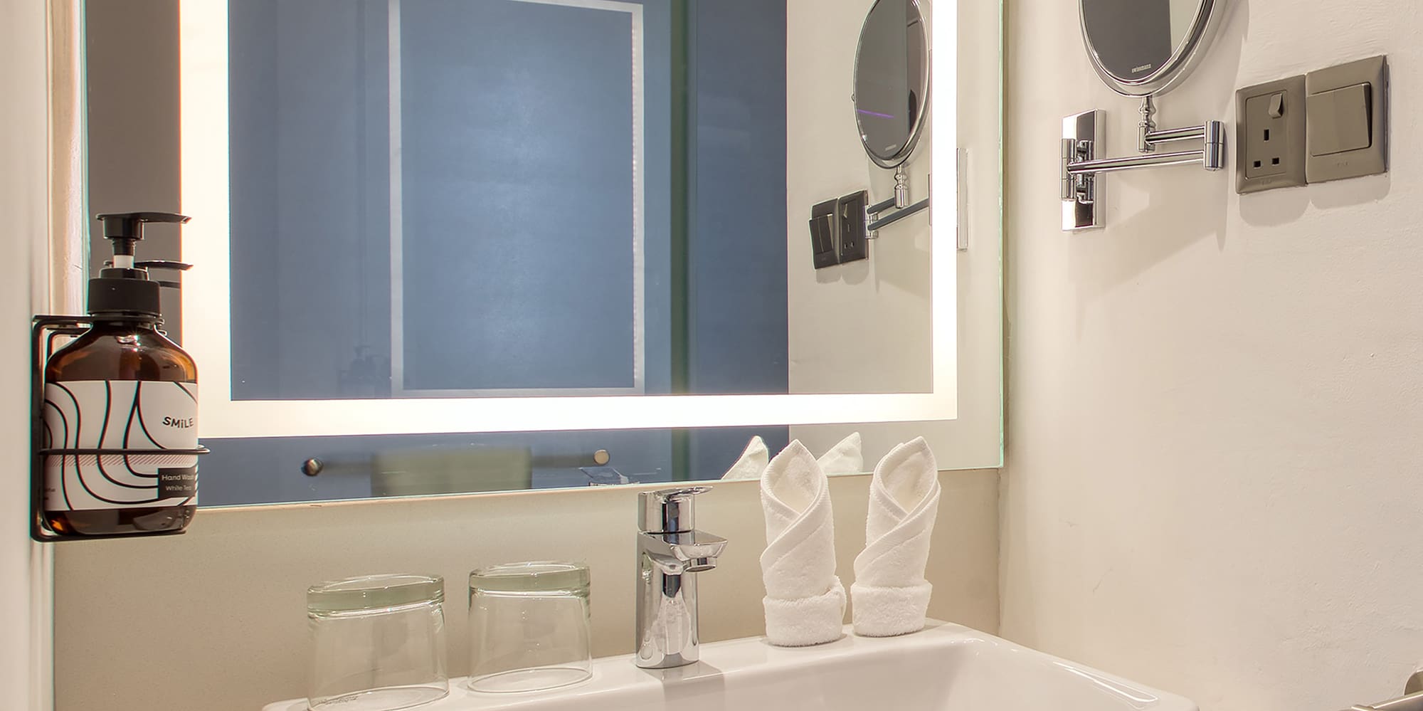 a bathroom with a mirror and sink