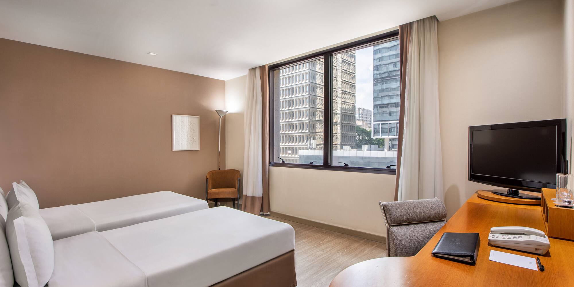 a room with two beds and a desk