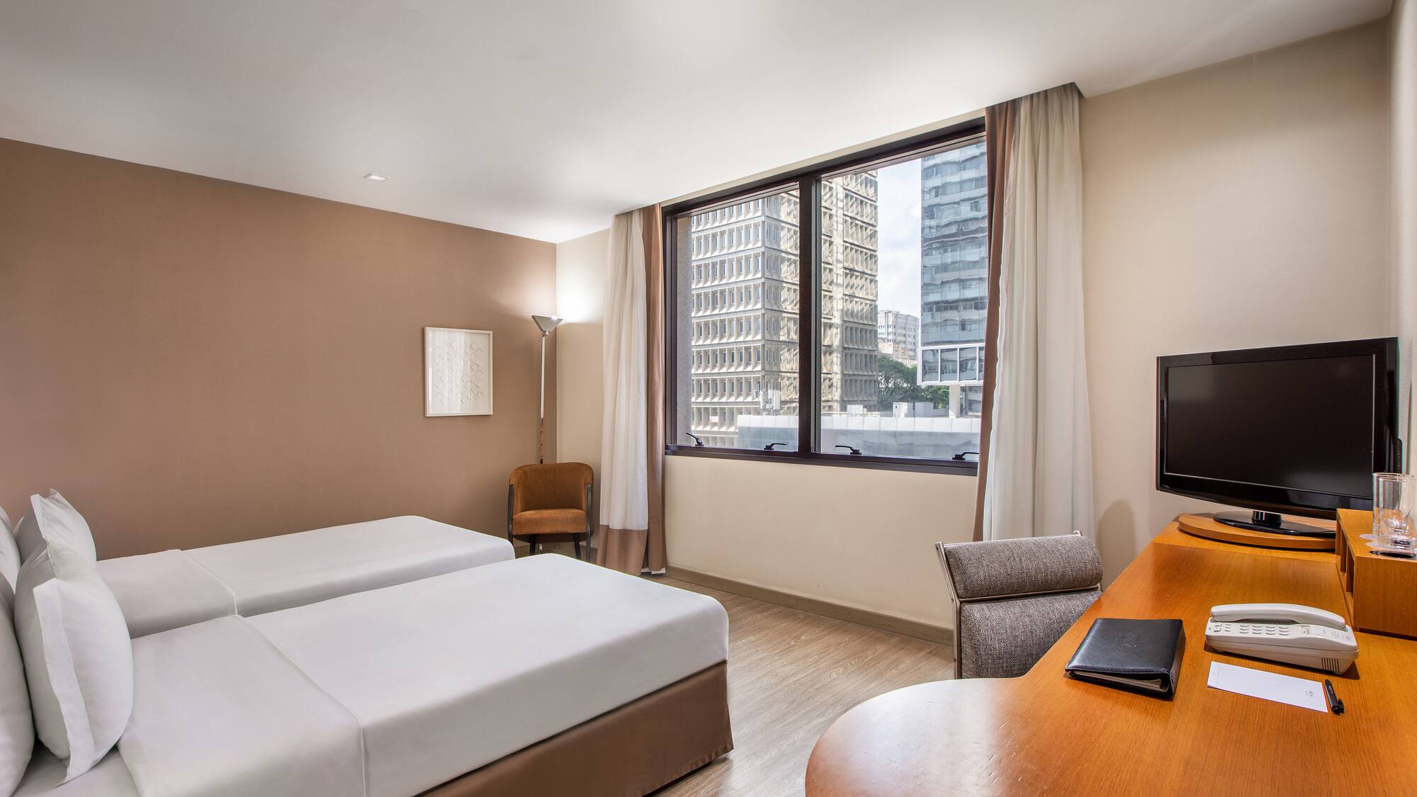 a room with two beds and a desk