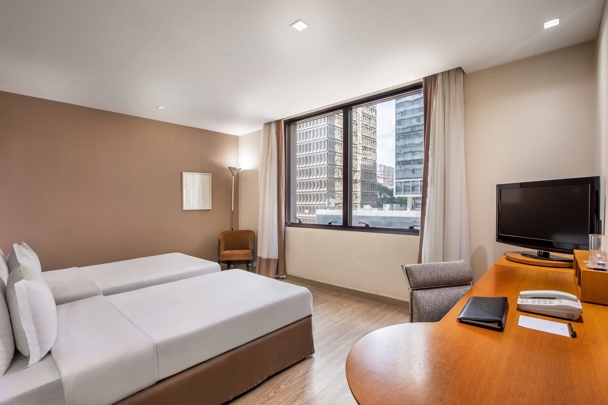 a room with two beds and a desk