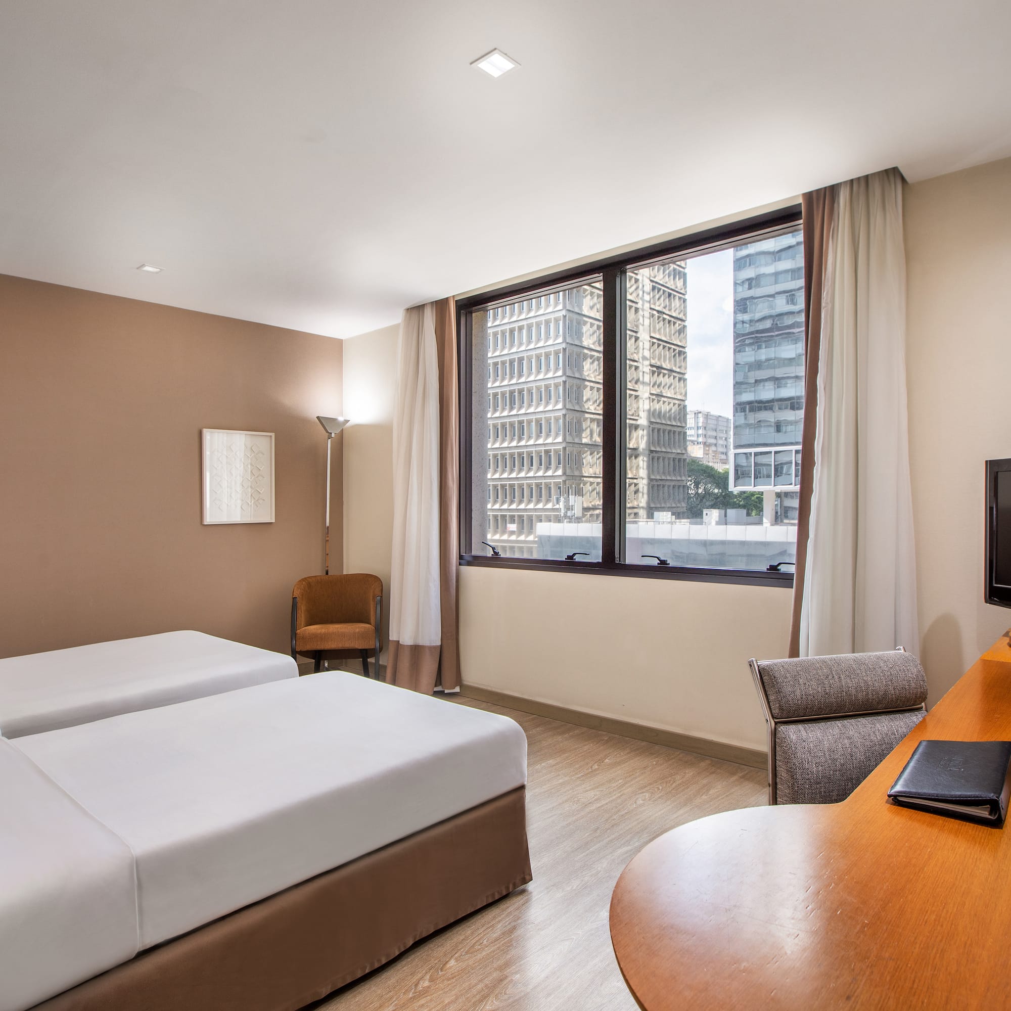 a room with two beds and a desk