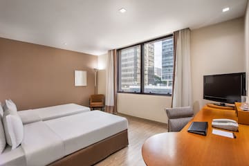 a room with two beds and a desk