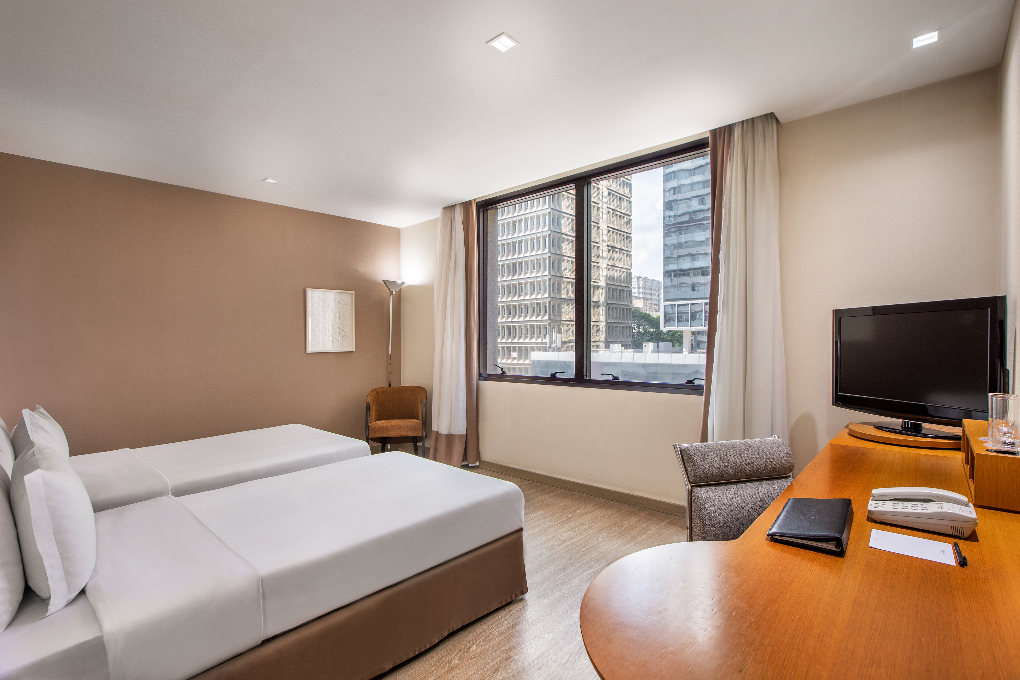 a room with two beds and a desk