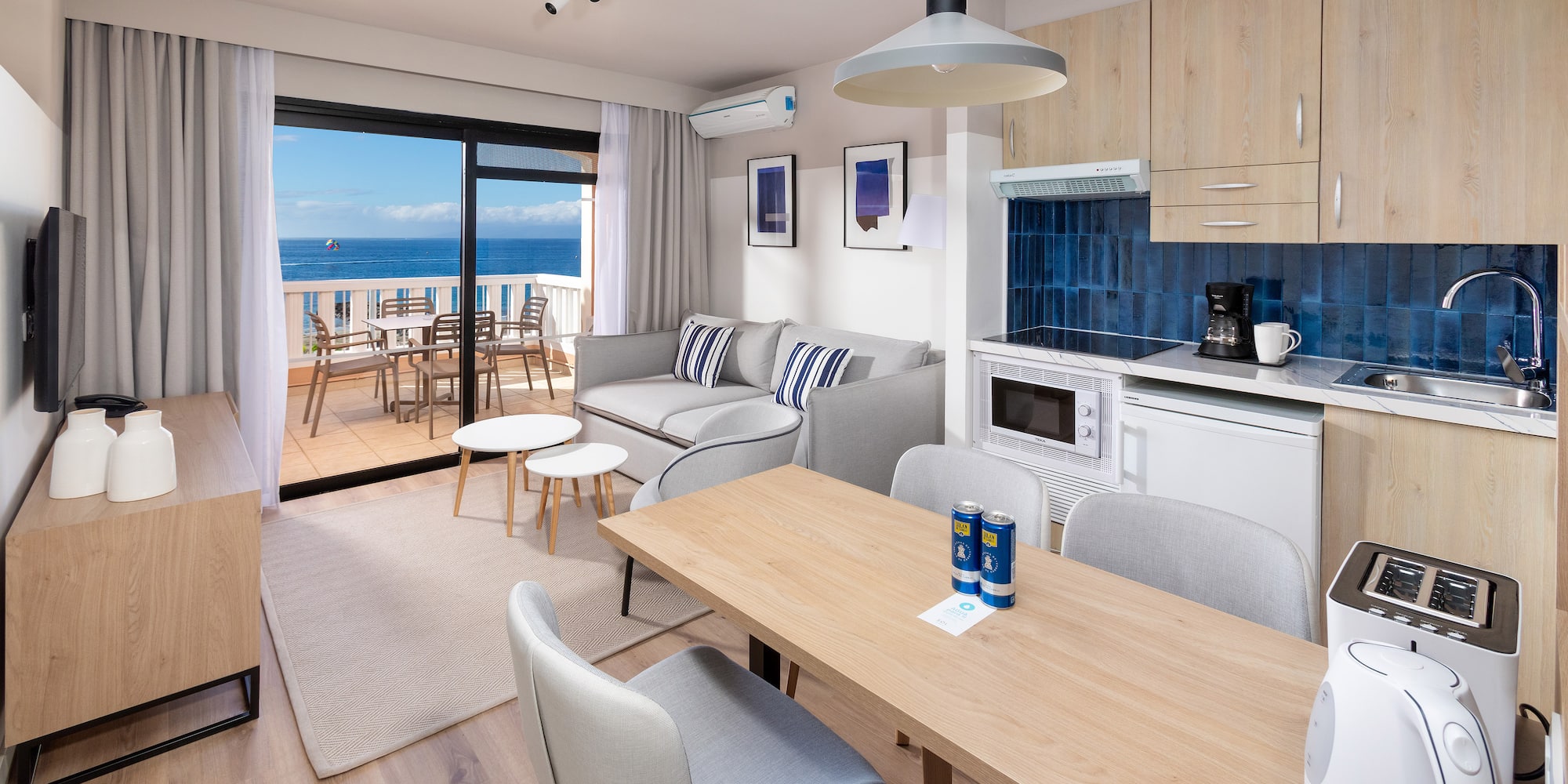 a room with a table and chairs and a glass door