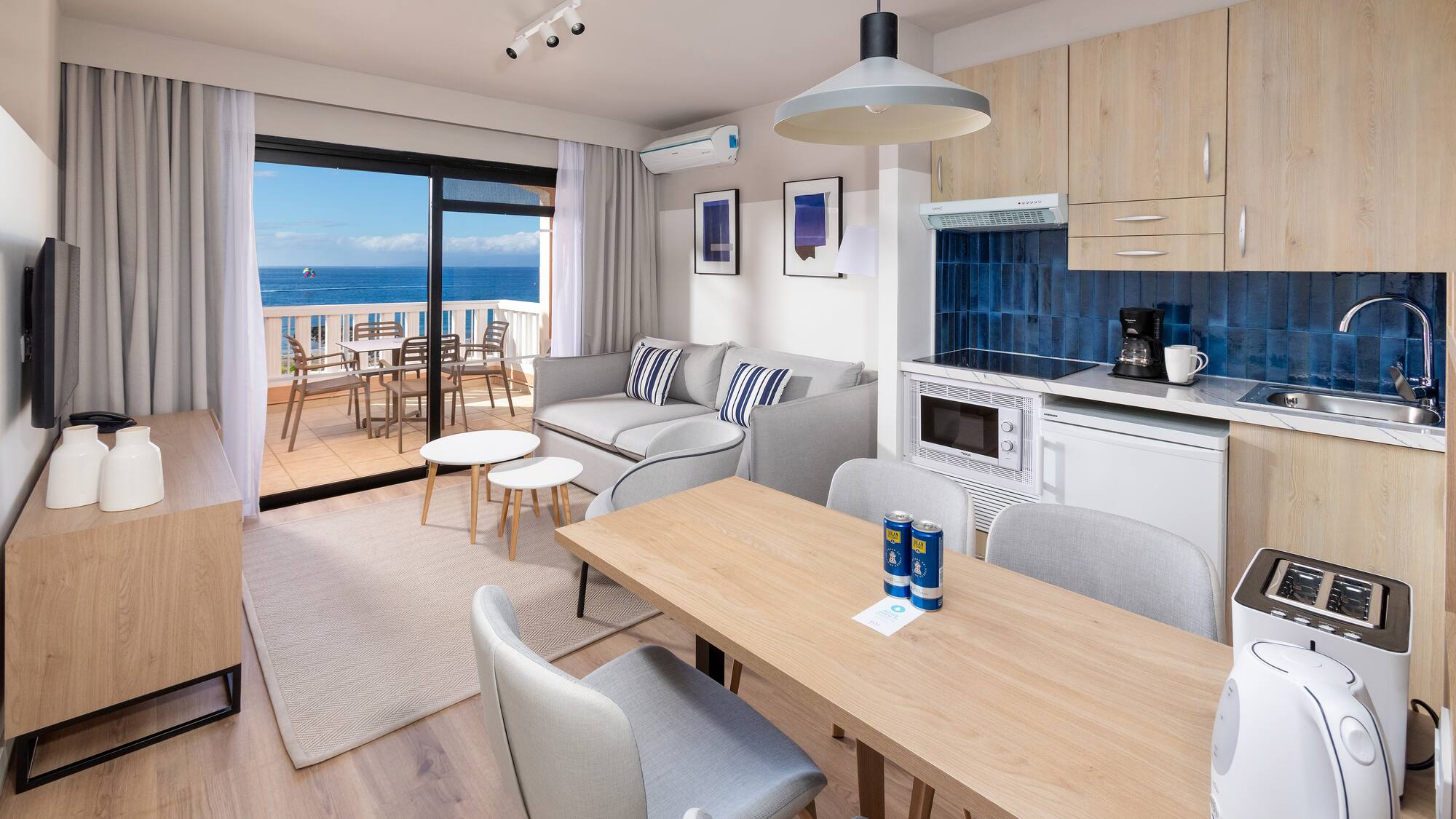 a room with a table and chairs and a glass door