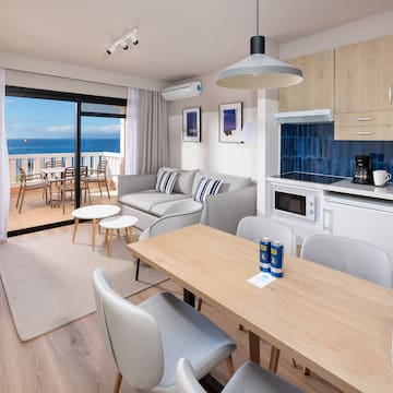 a room with a table and chairs and a glass door