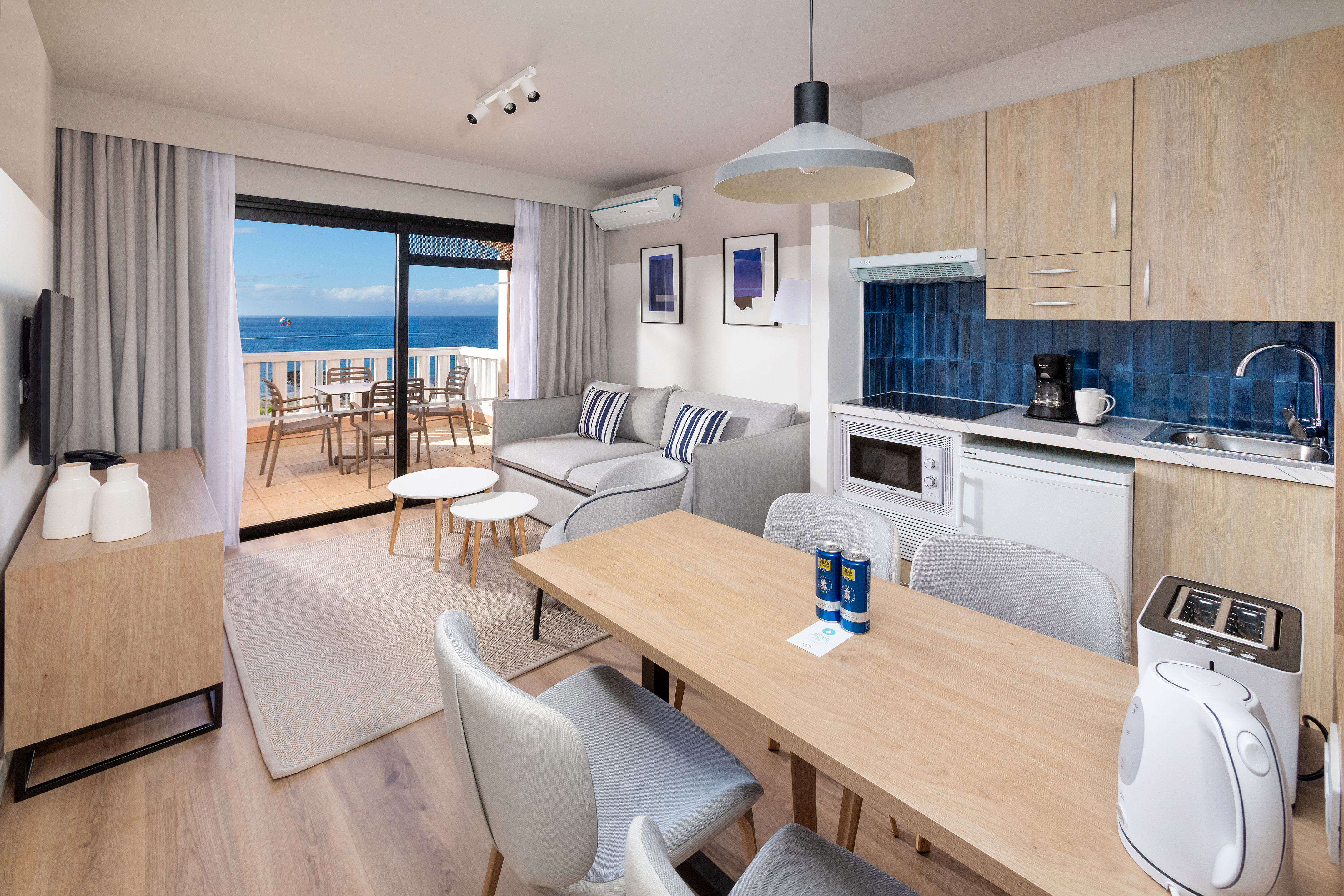 Modern apartment living room kitchen with sea view balcony.