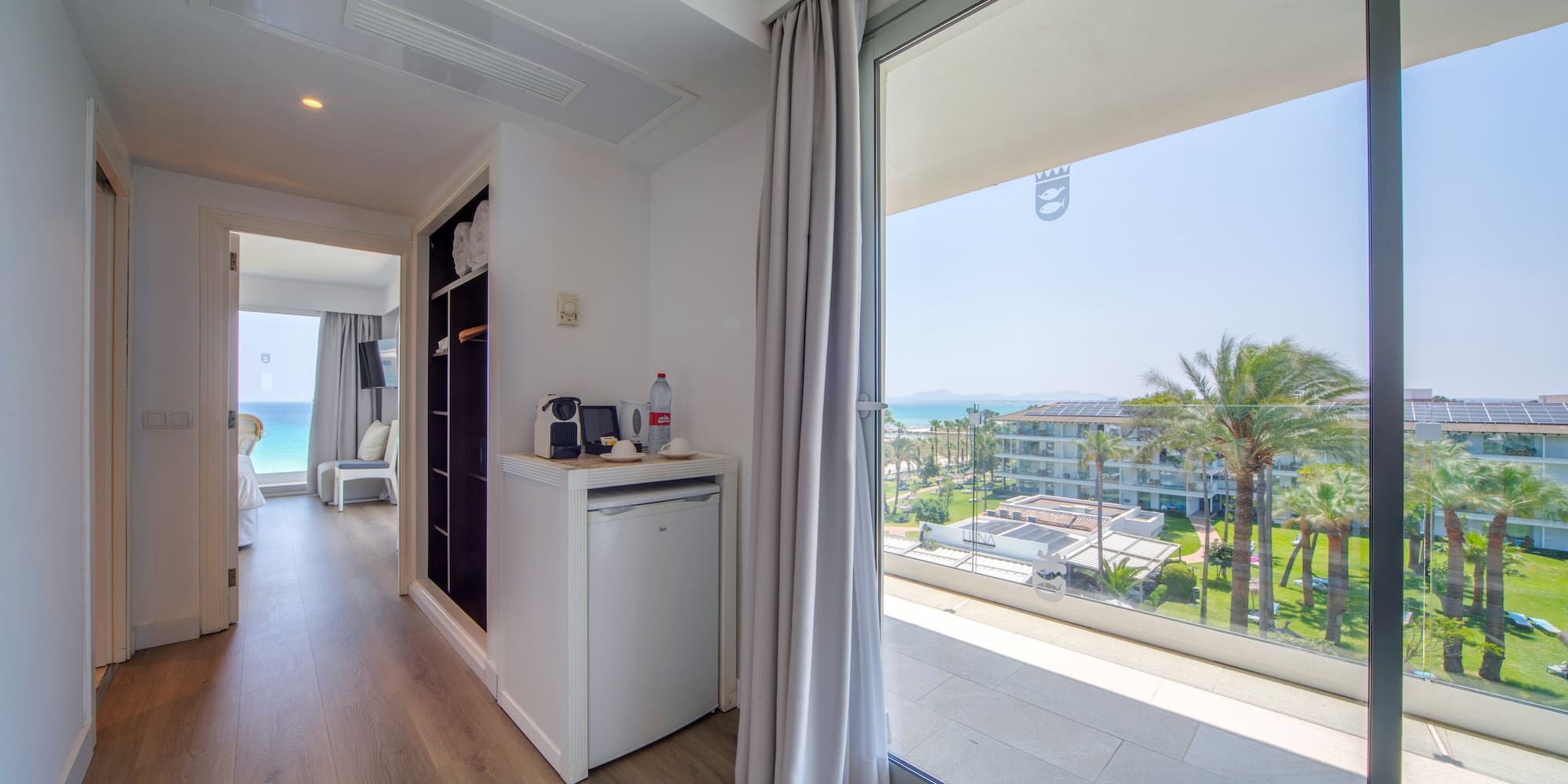 a room with a view of the ocean and a beach