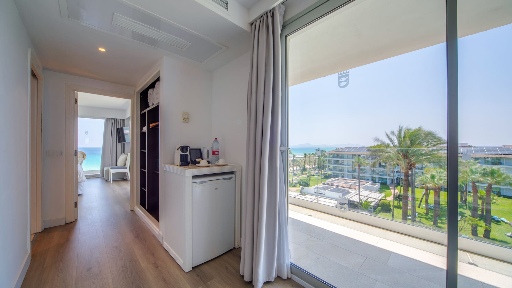 a room with a view of the ocean and a beach
