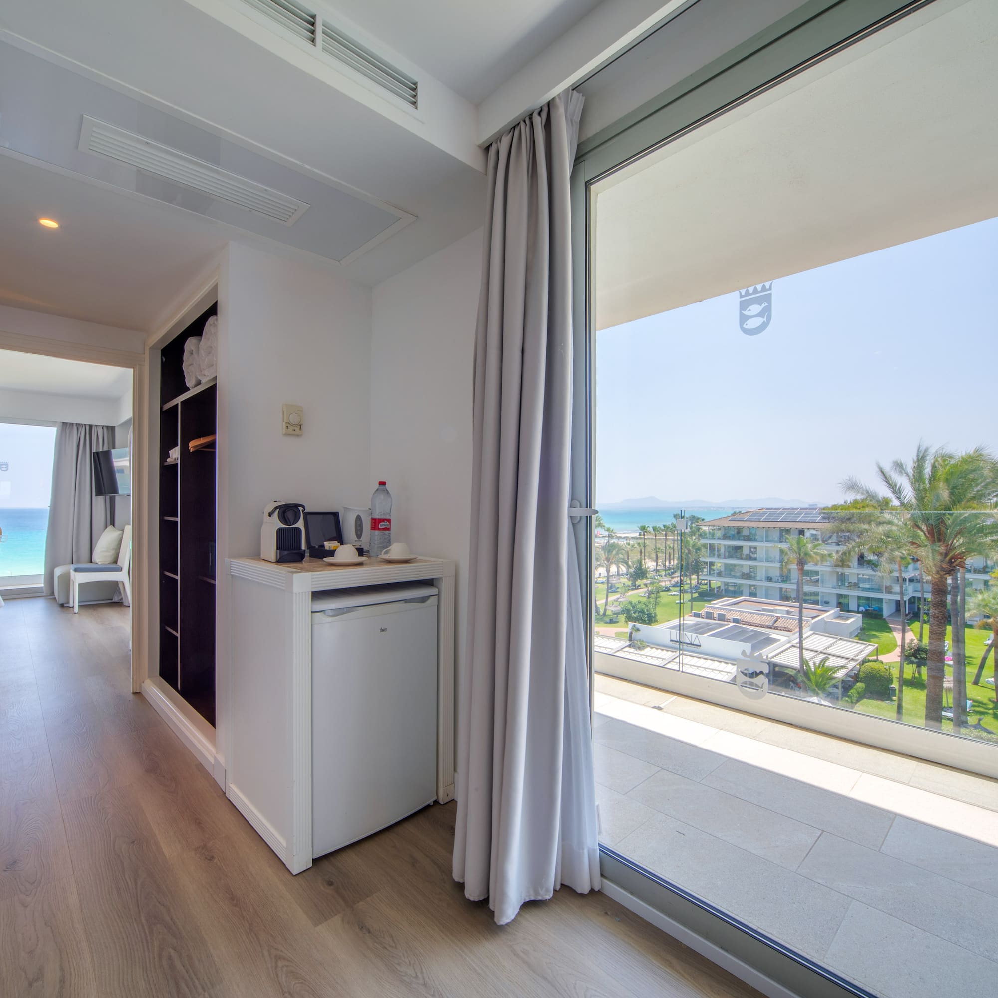 a room with a view of the ocean and a beach