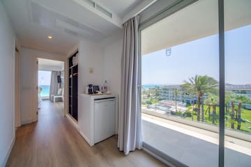 a room with a view of the ocean and a beach